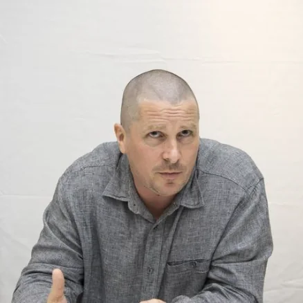 First photo: a man with a shaved head in a grey shirt